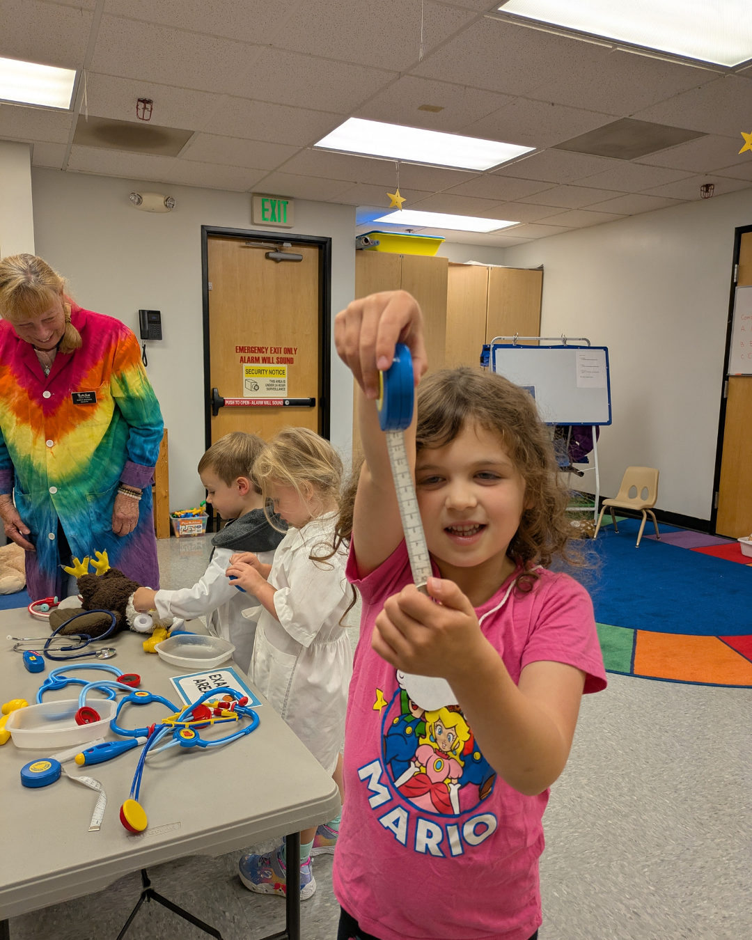 Camper learning to use a measuring tape