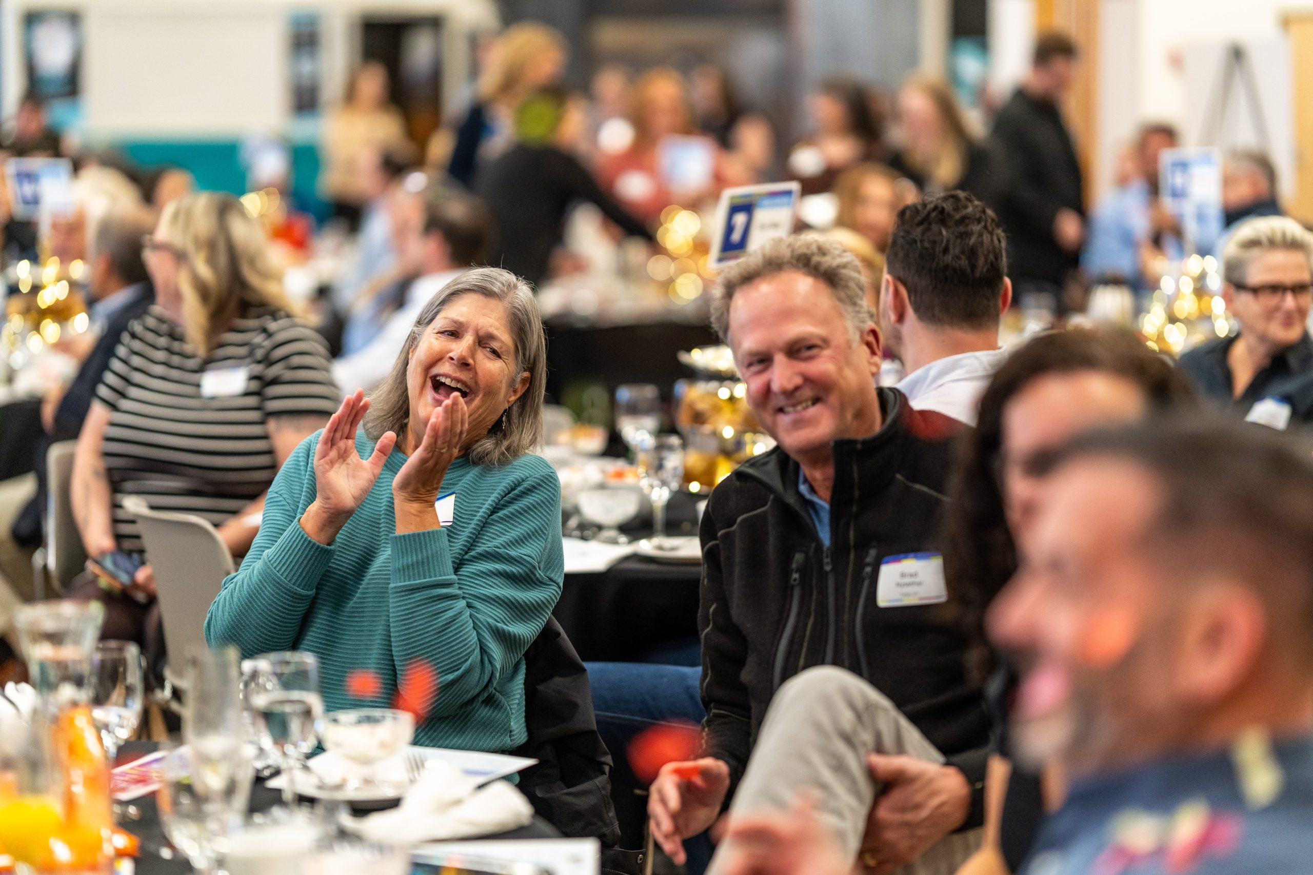 Guests gathered around a table at Imagine Children's Museum's morning fundraiser