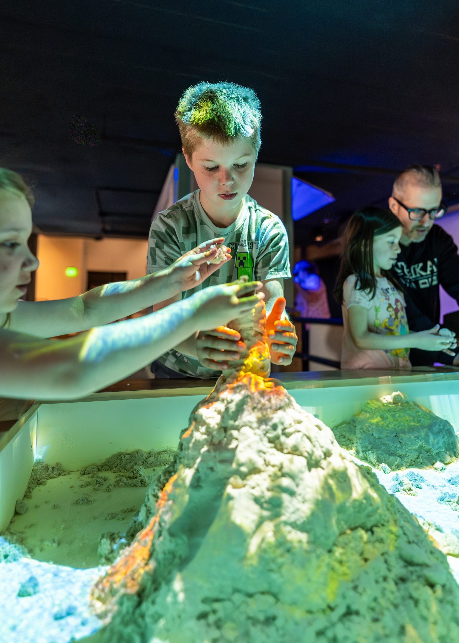 A family sharing a playful moment at Imagine Children’s Museum